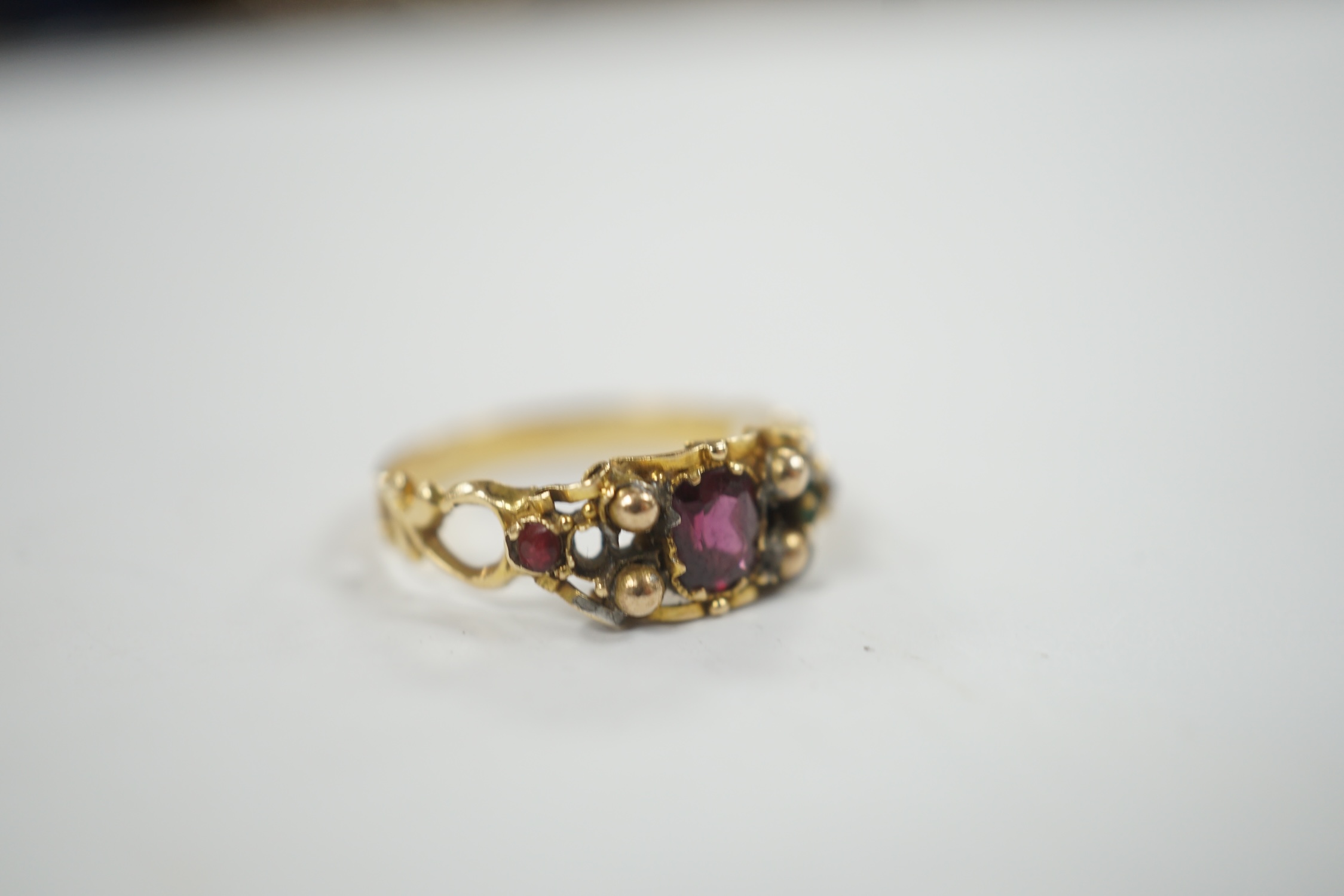 A Victorian yellow metal, garnet, ruby? and emerald set dress ring, (stones missing), size L, gross weight 1.8 grams.